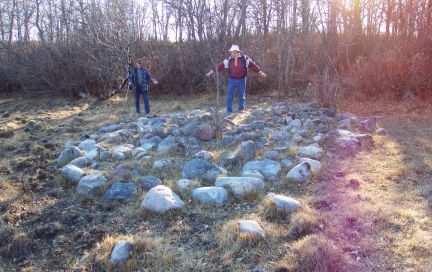 Photo: Jeff Cannon and Gord Powel stand a platform formed of closely set stones.